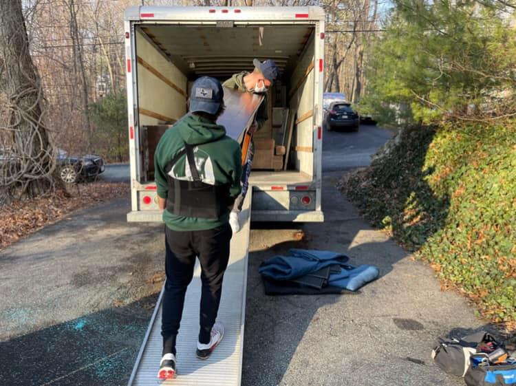 An image of Varsity Movers LLC workers loading a truck with items.